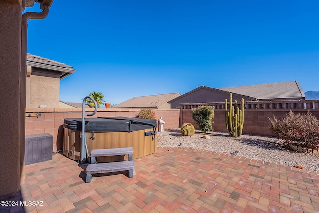 view of patio / terrace with a hot tub