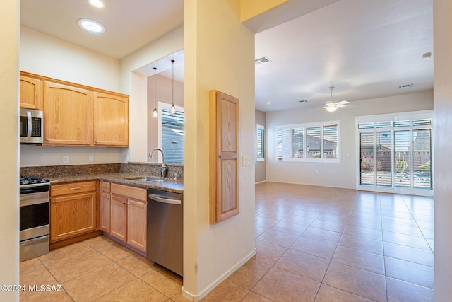 kitchen featuring appliances with stainless steel finishes, ceiling fan, sink, light tile patterned floors, and pendant lighting