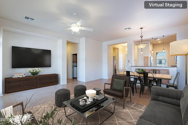 tiled living room with ceiling fan