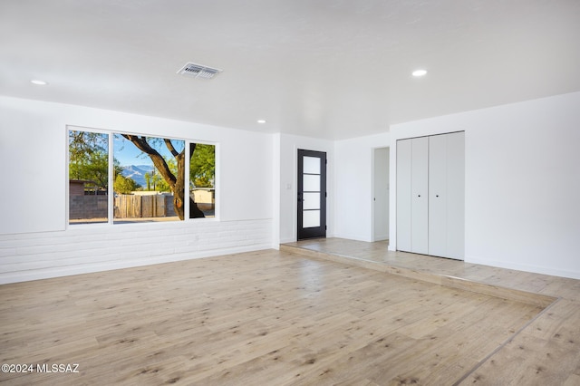 spare room featuring light wood-type flooring