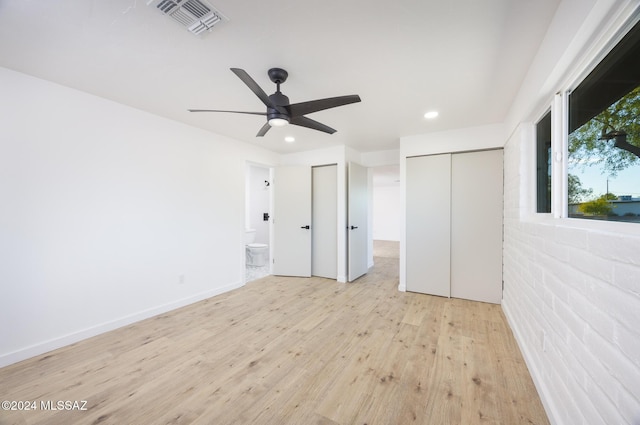 unfurnished bedroom featuring ceiling fan, connected bathroom, and light hardwood / wood-style flooring