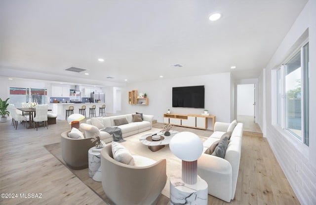 living room featuring light hardwood / wood-style flooring and a wealth of natural light