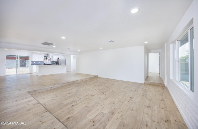 unfurnished living room with light wood-type flooring