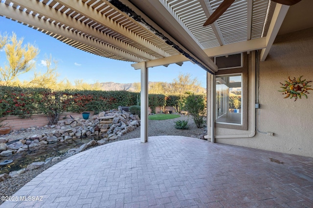 view of patio featuring a mountain view and a pergola