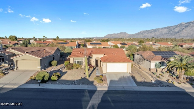 view of front facade with a mountain view and a garage