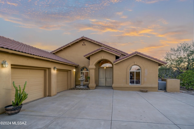 mediterranean / spanish house featuring a garage