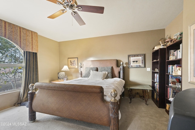 bedroom with ceiling fan and light carpet