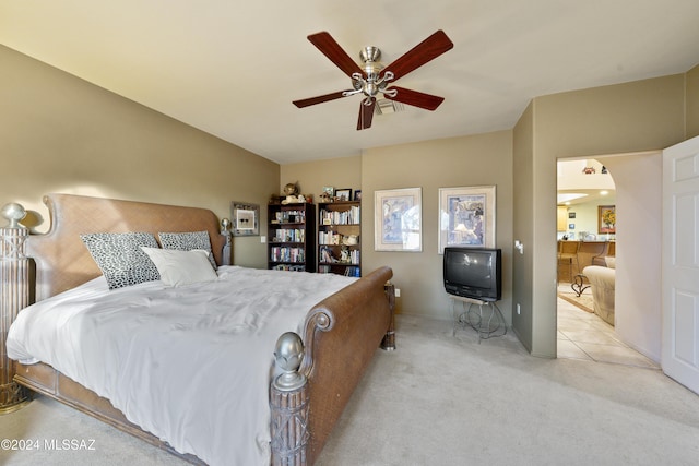 bedroom featuring light carpet and ceiling fan