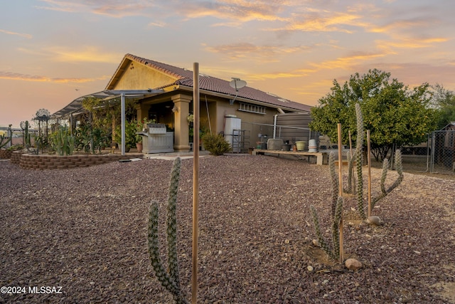 view of back house at dusk