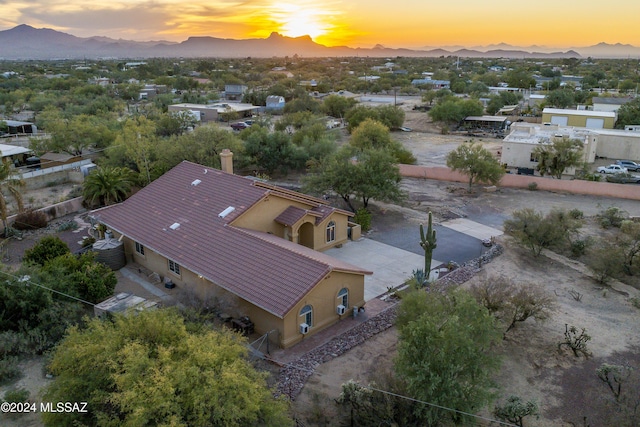 aerial view at dusk featuring a mountain view