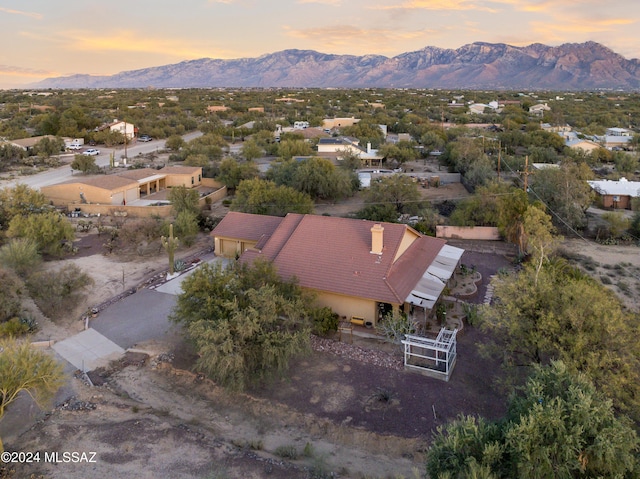 aerial view at dusk featuring a mountain view