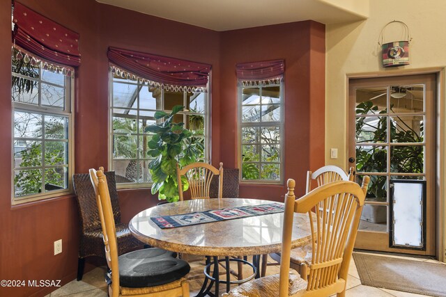 dining space with a wealth of natural light and light tile patterned floors