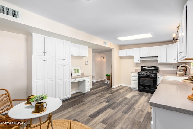 kitchen with sink, white cabinets, dark hardwood / wood-style floors, and black gas range oven