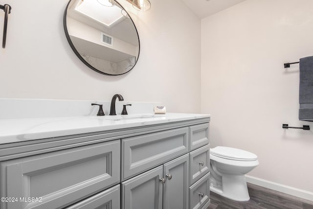 bathroom featuring vanity, toilet, and wood-type flooring