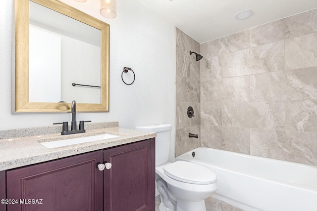 full bathroom with toilet, vanity, and tiled shower / bath