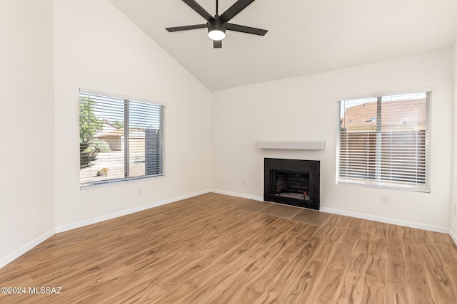 unfurnished living room featuring hardwood / wood-style floors, high vaulted ceiling, and ceiling fan