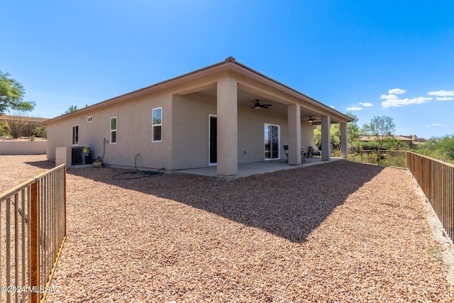 back of property with a patio, ceiling fan, and cooling unit