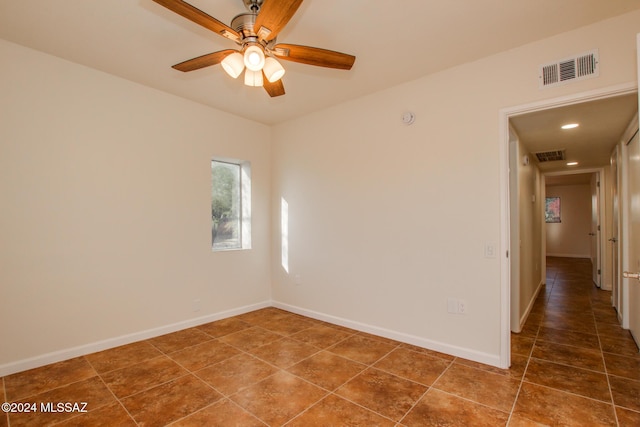 tiled empty room with ceiling fan