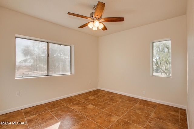 unfurnished room with ceiling fan and tile patterned flooring