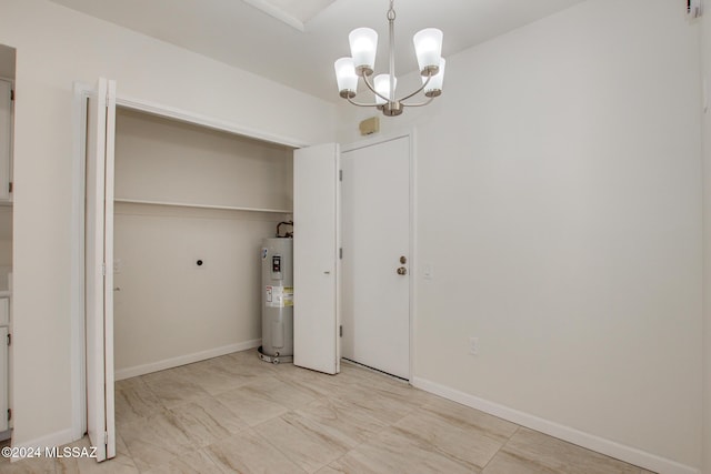 washroom with electric dryer hookup, water heater, and a chandelier