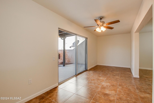 tiled empty room featuring ceiling fan