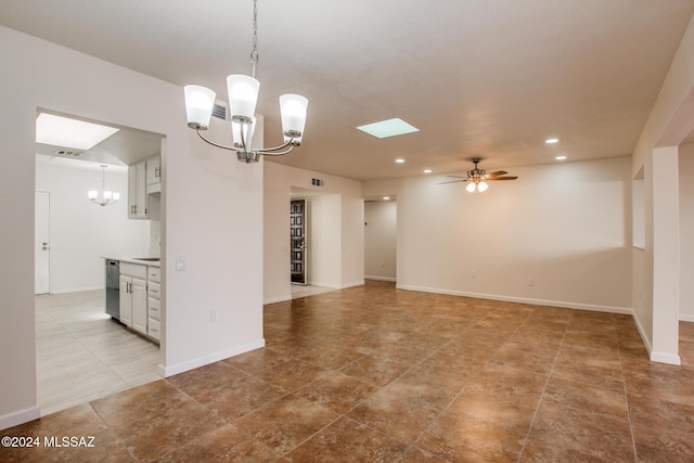 empty room featuring ceiling fan with notable chandelier