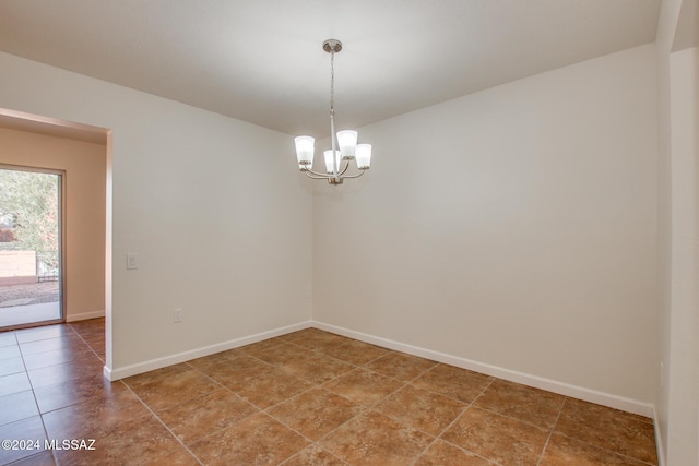 tiled empty room with a notable chandelier