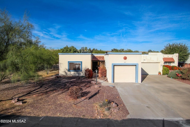 southwest-style home featuring a garage