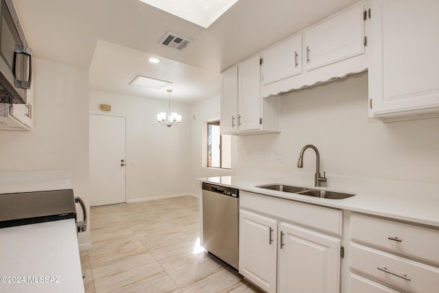 kitchen featuring white cabinetry, stainless steel dishwasher, hanging light fixtures, and sink