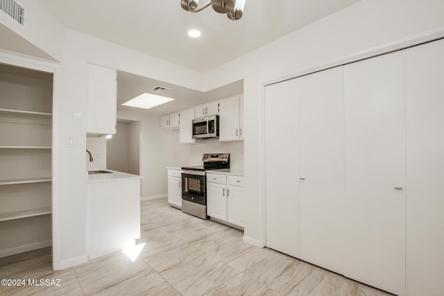 kitchen with white cabinets, stainless steel appliances, and sink