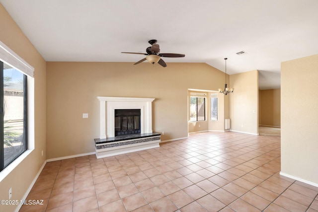 unfurnished living room featuring ceiling fan with notable chandelier, plenty of natural light, light tile patterned floors, and lofted ceiling