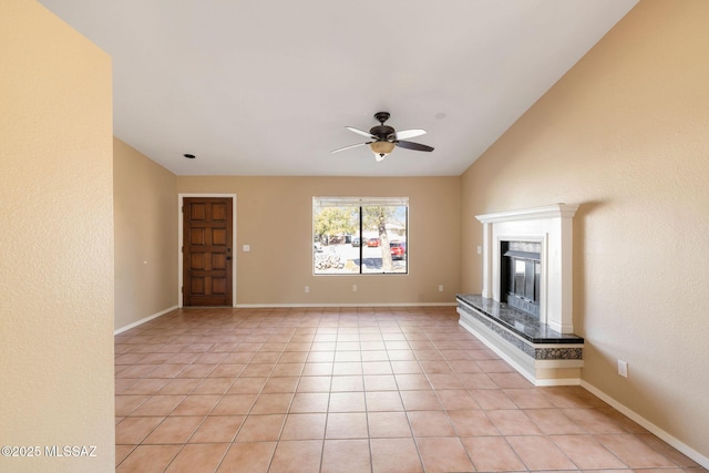 unfurnished living room featuring ceiling fan, a fireplace, and light tile patterned flooring