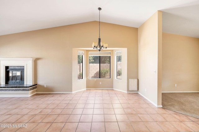 unfurnished living room with light tile patterned floors, a high end fireplace, lofted ceiling, and a chandelier