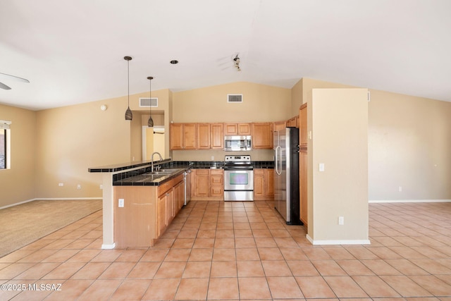 kitchen featuring pendant lighting, appliances with stainless steel finishes, sink, kitchen peninsula, and light tile patterned flooring