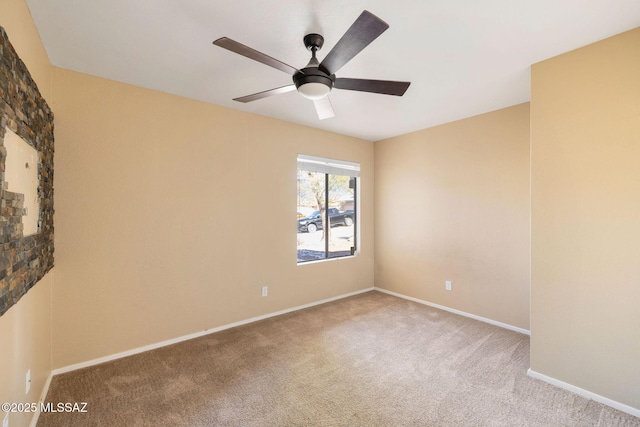 spare room featuring carpet and ceiling fan