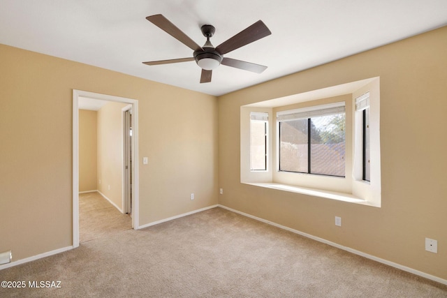 unfurnished room featuring ceiling fan and light colored carpet