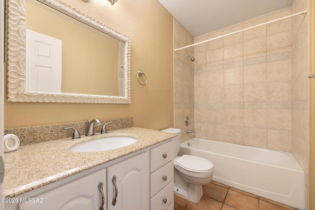 full bathroom featuring tiled shower / bath combo, vanity, toilet, and tile patterned flooring