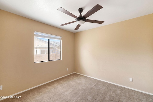 carpeted spare room with ceiling fan