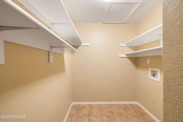 laundry area with light tile patterned floors and hookup for a washing machine