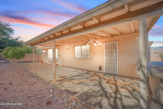 patio terrace at dusk with ceiling fan