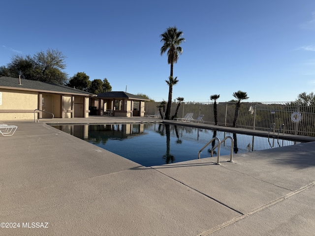 view of swimming pool featuring a gazebo and a patio