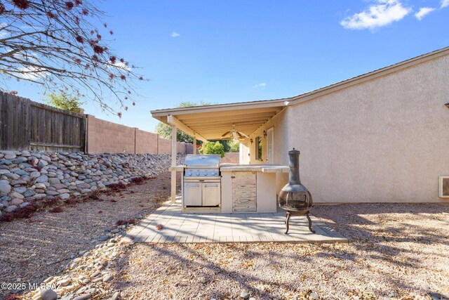 view of patio / terrace with ceiling fan, an outdoor fire pit, grilling area, and area for grilling