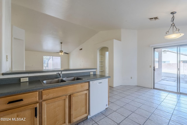 kitchen with dark countertops, visible vents, white dishwasher, and a sink