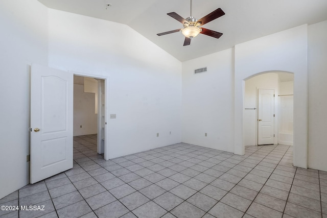 tiled spare room featuring ceiling fan and high vaulted ceiling