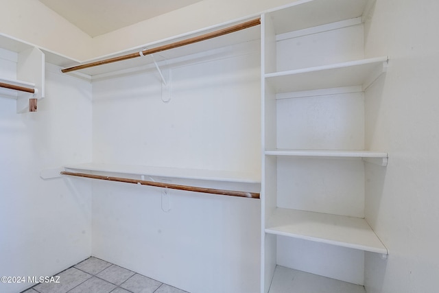 walk in closet with tile patterned flooring