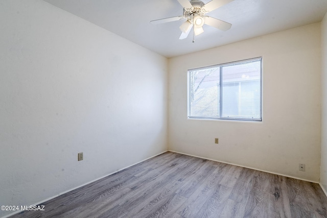 spare room with light hardwood / wood-style flooring and ceiling fan