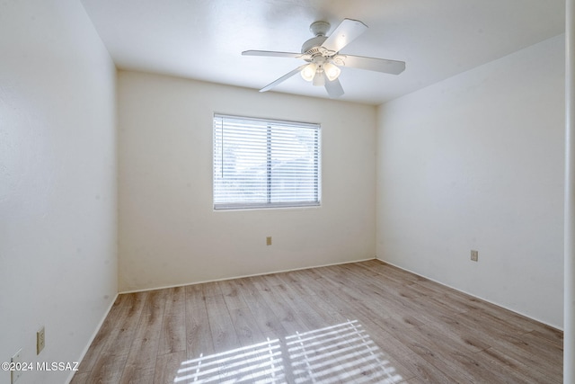 spare room featuring light hardwood / wood-style flooring and ceiling fan