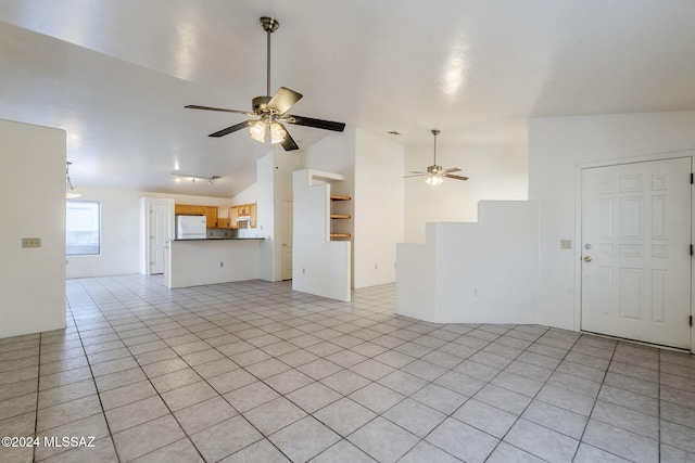 unfurnished living room with ceiling fan, light tile patterned floors, and vaulted ceiling