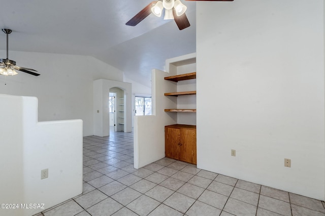 tiled spare room with ceiling fan and vaulted ceiling