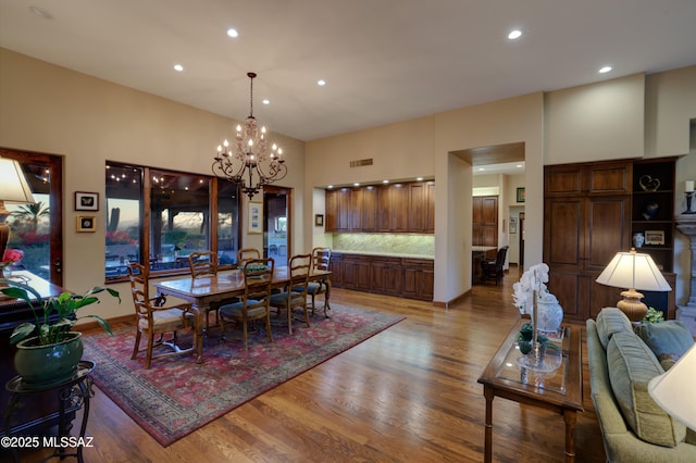 dining space with a notable chandelier and hardwood / wood-style floors